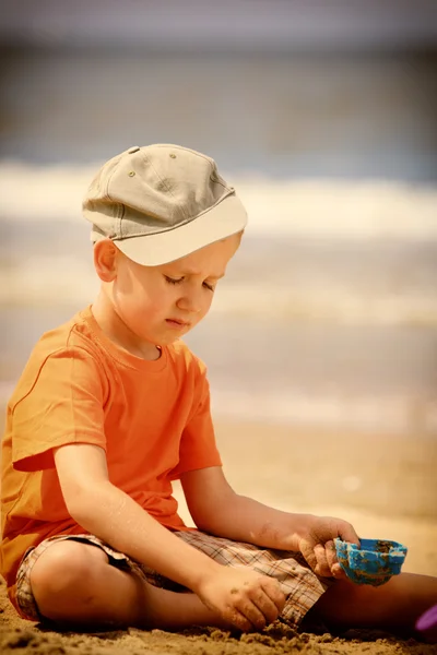 Jongen speelgoed spelen op strand — Stockfoto