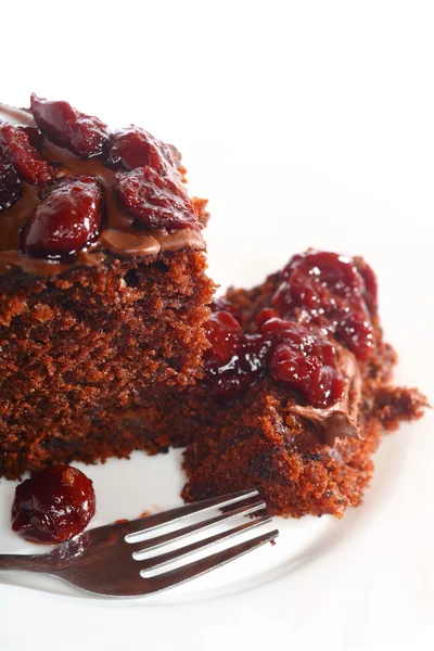 Piece of chocolate cake with icing and cherry — Stock Photo, Image