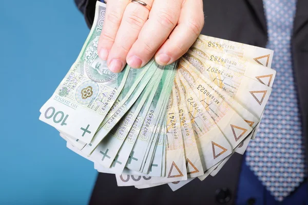 Podnikatel držení peněz polských bankovek — Stock fotografie