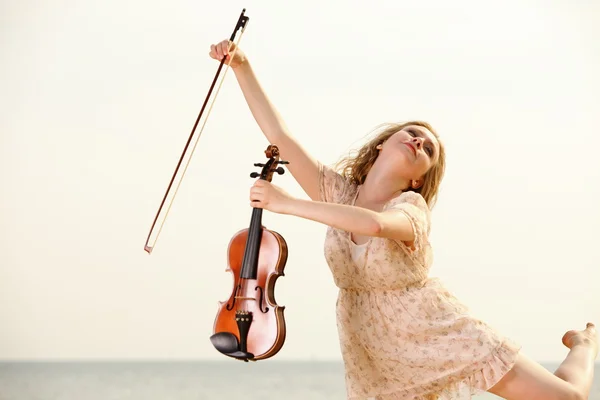 Happy blonde girl with a violin outdoor — Stock Photo, Image