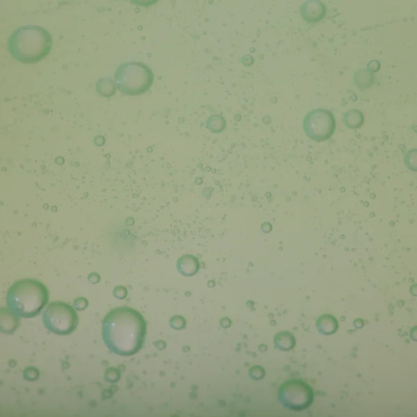 Bolle di sapone verde fondo liquido — Foto Stock