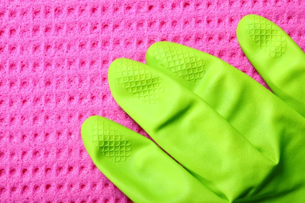 Pink sponge and green rubber glove — Stock Photo, Image