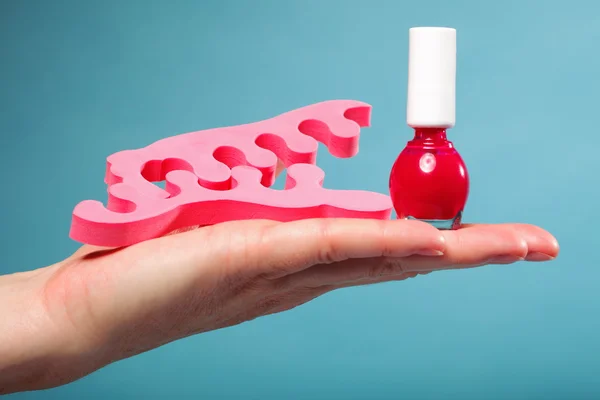 Foot pedicure red nail polish and toe separators — Stock Photo, Image