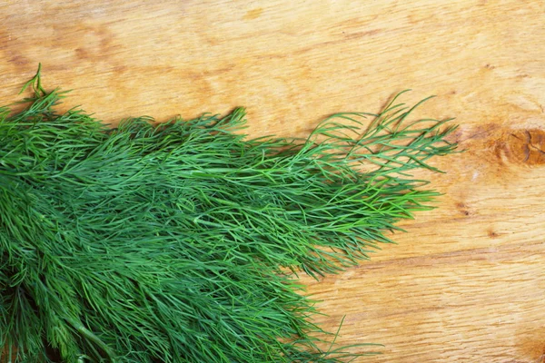 Bunch fresh dill herb on wooden table — Stock Photo, Image