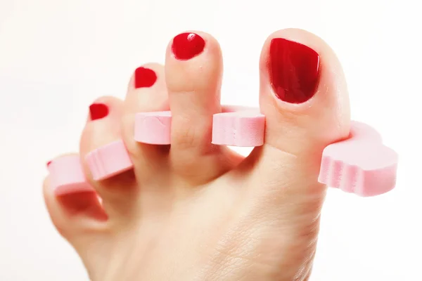 Foot pedicure applying red toenails on white — Stock Photo, Image