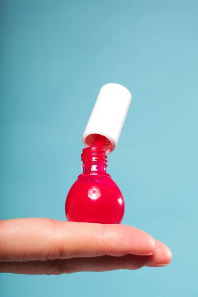 Pedicure manicure red nail polish on female palm — Stock Photo, Image