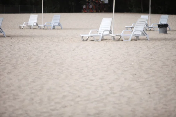 White pool chairs on sand beach — Stock Photo, Image