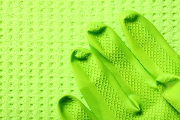 Green sponge and green rubber glove — Stock Photo, Image