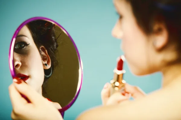 Girl in curlers styling hair applying make up — Stock Photo, Image