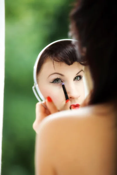 Girl applying make up reflection in mirror — Stock Photo, Image