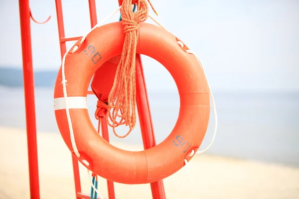 Lifeguard beach rescue equipment orange lifebuoy — Stock Photo, Image