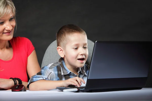 Mother with son looking on the laptop — Stock Photo, Image