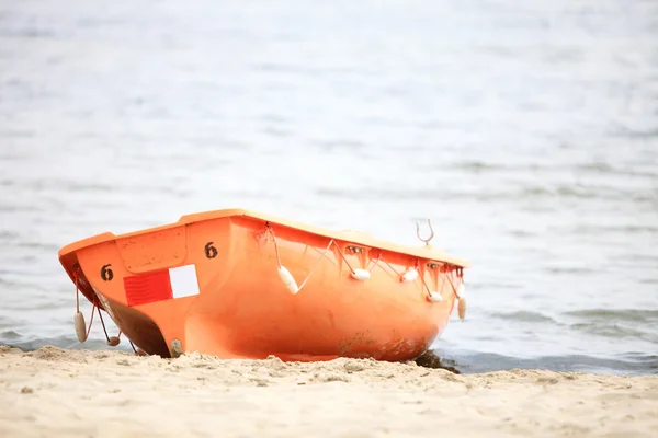 Lifeguard beach rescue equipment orange boat — Stock Photo, Image