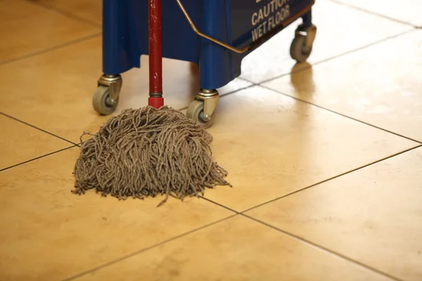 Cleaning the floor with a mop — Stock Photo, Image