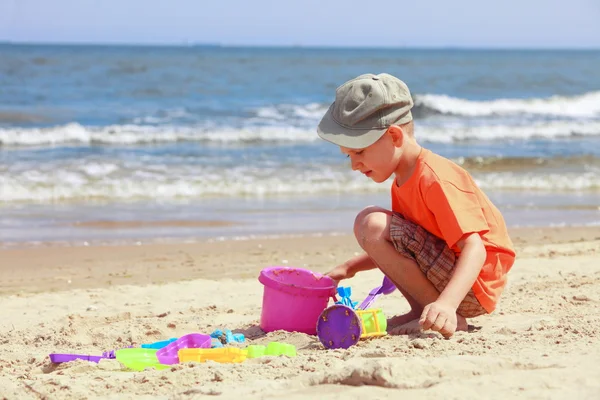 Boy playing toys on beach Royalty Free Stock Images