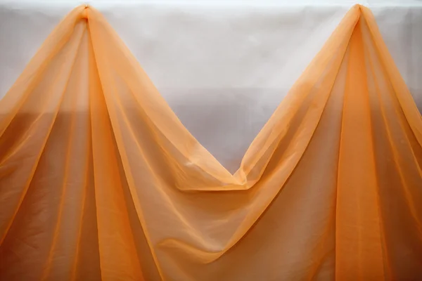Orange fabric cloth and white wall decor detail — Stock Photo, Image