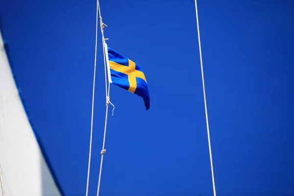 Swedish flag on ship blue sky on background — Stock Photo, Image