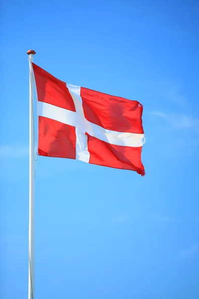 Danish flag with blue sky on background — Stock Photo, Image