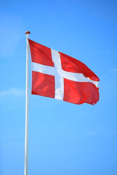 Danish flag with blue sky on background — Stock Photo, Image