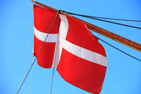 Danish flag on ship blue sky background — Stock Photo, Image