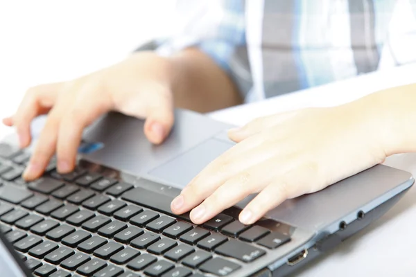 Boy's hand typing on laptop keyboard — Stock Photo, Image