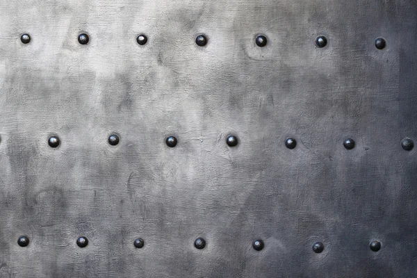 Black metal plate or armour texture with rivets — Stock Photo, Image