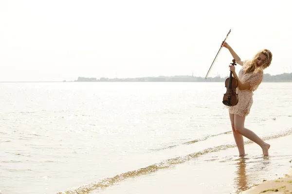 Happy blonde girl with a violin outdoor — Stock Photo, Image