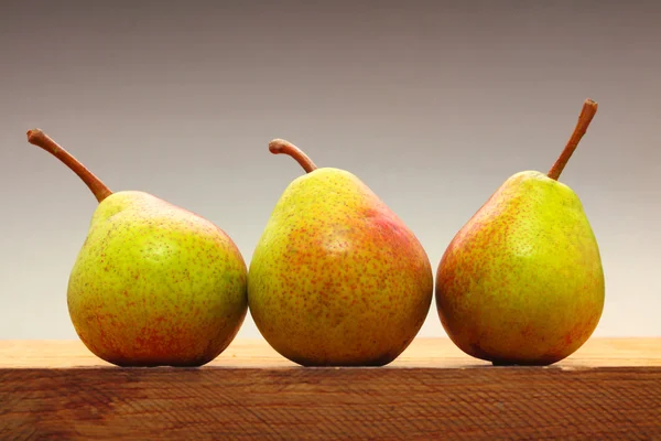 Trois poires fruits sur table en bois — Photo