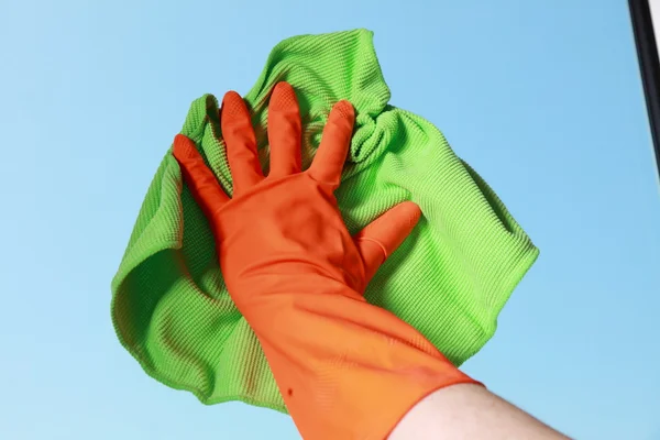 Gloved hand cleaning window with rag — Stock Photo, Image