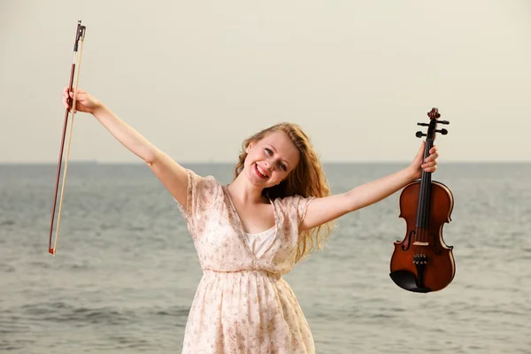 Happy blonde girl with a violin outdoor — Stock Photo, Image