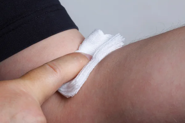 Appying a swab to an arm after blood sample — Stock Photo, Image