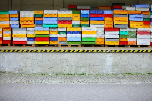 Colorful boxes plastic crates containers for fish — Stock Photo, Image