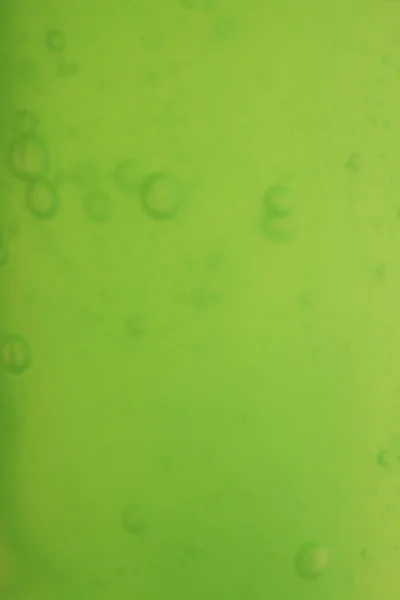 Gelembung sabun latar belakang cair hijau — Stok Foto