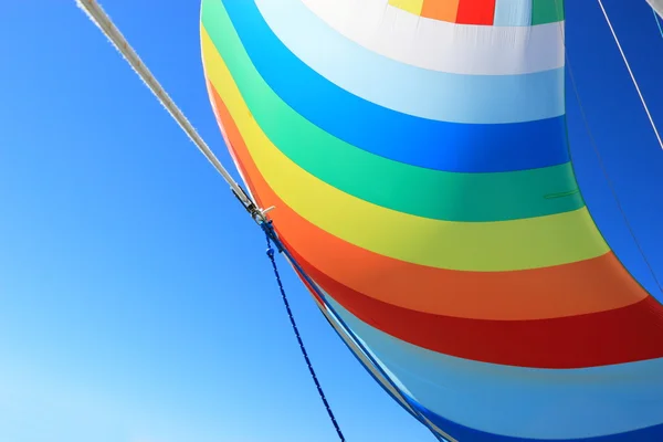 The wind has filled colorful spinnaker sail — Stock Photo, Image