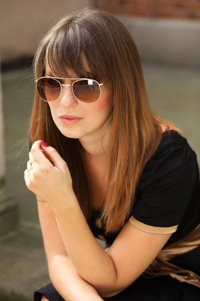 Thoughtful woman on street of old town — Stock Photo, Image