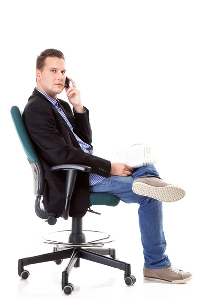 Man reads newspaper phoning - economy news — Stock Photo, Image