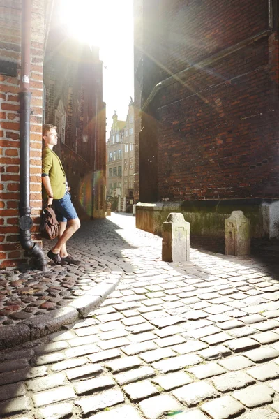 Young man with bag on street, old town Gdansk — Stock Photo, Image