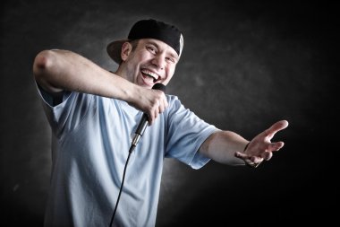 Rap singer man with microphone cool hand gesture clipart