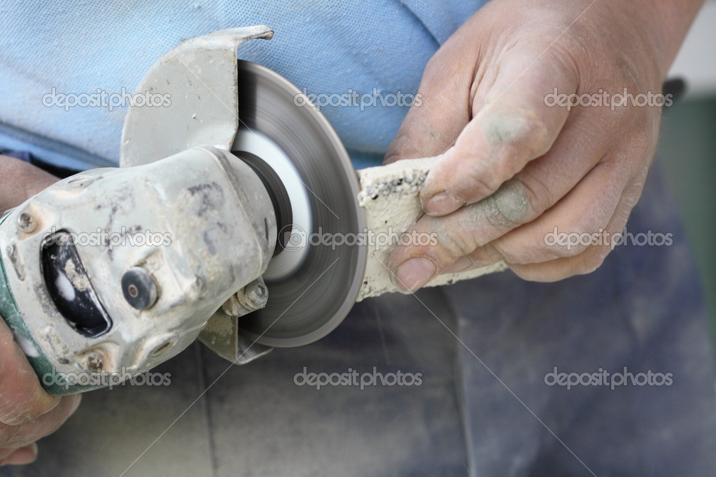 Construction Worker Using An Angle Grinder Cutting Tile Stock Construction Worker Using An Angle Grinder Cutting Tile Stock Photo