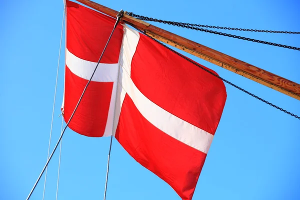 Danish flag on ship blue sky background — Stock Photo, Image