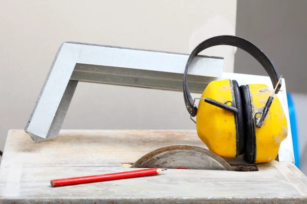 Work tools saw cutter to cut tile, protective headphones — Stock Photo, Image