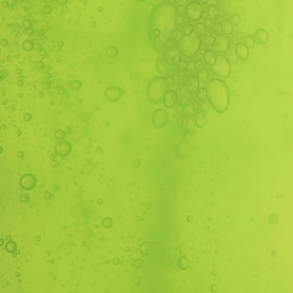 Jabón burbujas verde líquido fondo — Foto de Stock