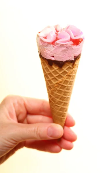 Berry icecream cone in hand on white — Stock Photo, Image