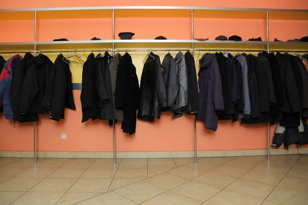 Many clothes in cloakroom — Stock Photo, Image