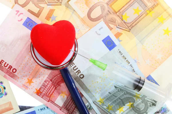 Cost of health care: stethoscope red heart on euro money — Stock Photo, Image