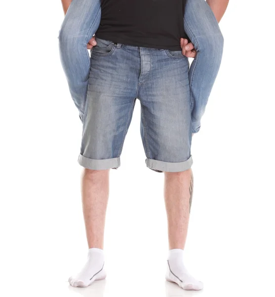 Lovers couple with a piggyback ride legs studio shot — Stock Photo, Image