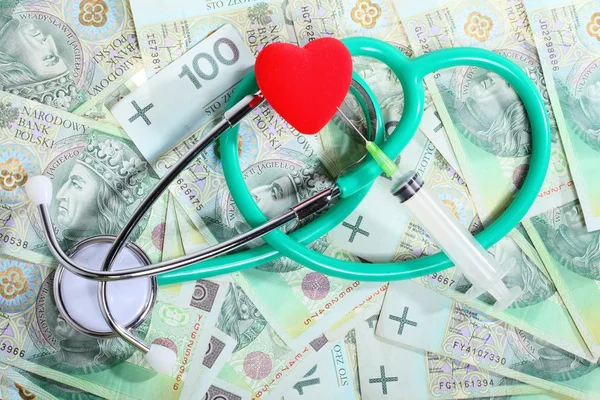 Cost of health care: stethoscope red heart polish money — Stock Photo, Image