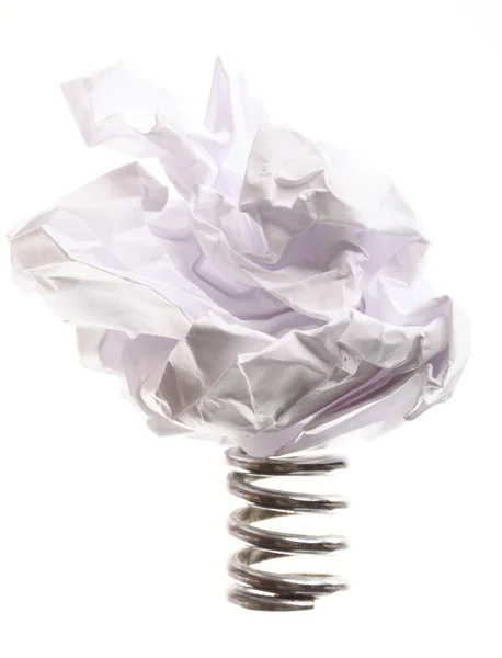 Crumpled paper ball on metal spring isolated — Stock Photo, Image