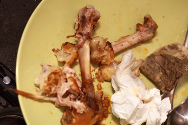 Dirty plate with bones after dinner. Food leftovers — Stock Photo, Image