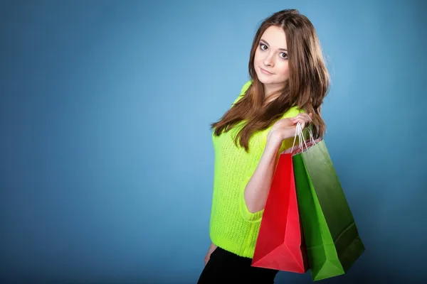 Young woman with paper multi coloured shopping bag — Stock Photo, Image